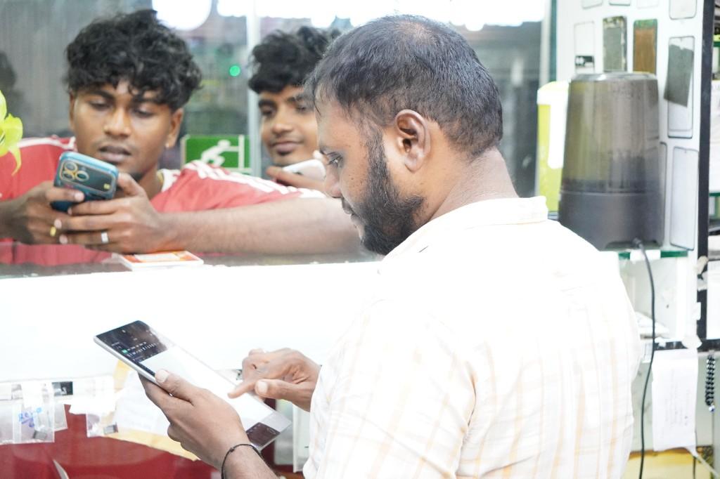 Apple and Android lead technician at the workshop counter